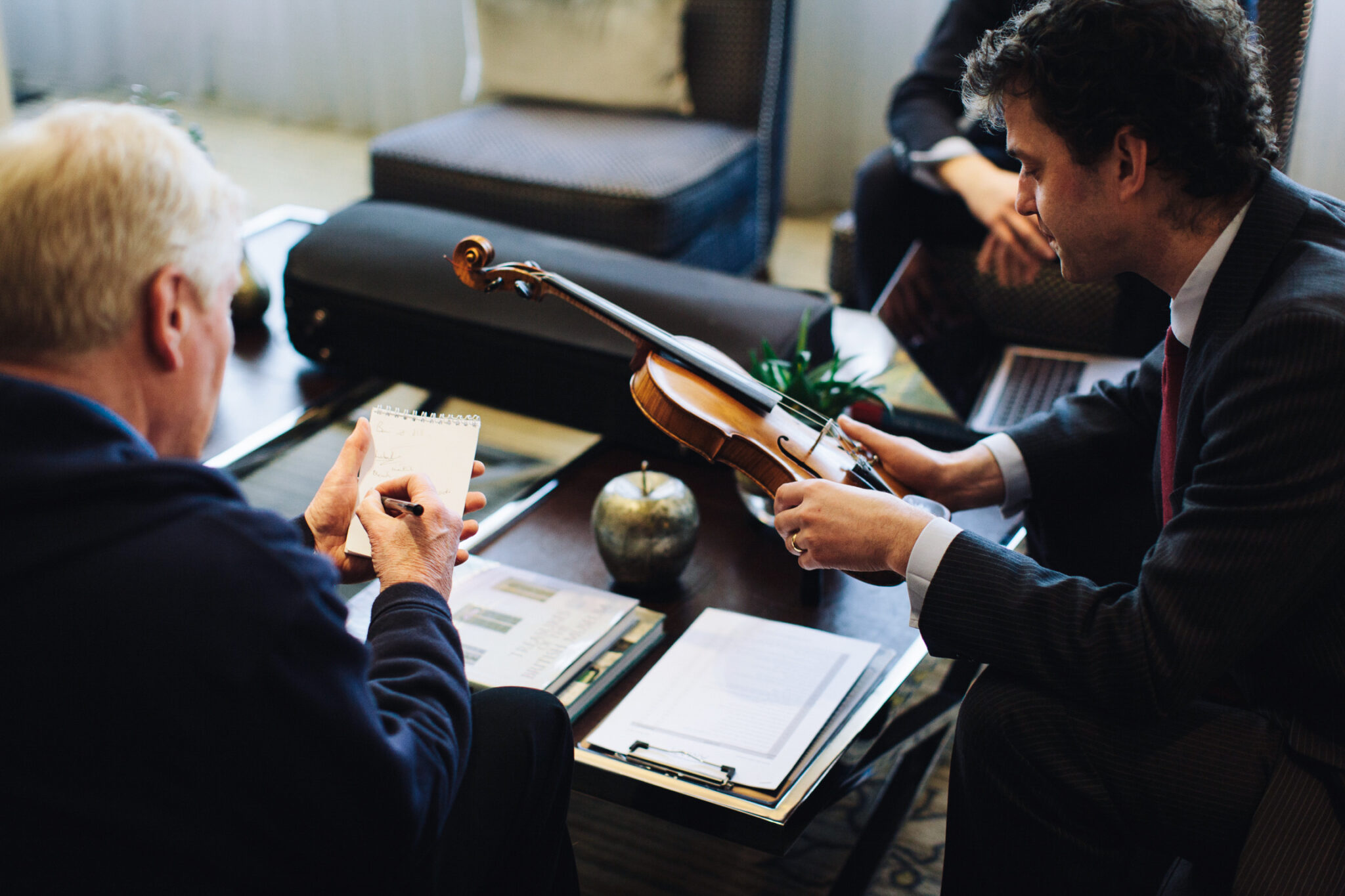 An Amati specialist valuing a violin with its owner
