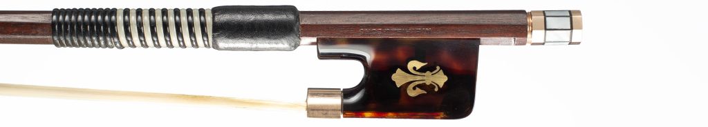 Gold fleur-de-lys inlay on the tortoiseshell frog of a W. E. Hill & Sons bow