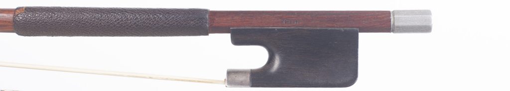 The frog end of a Hill bow, with the HILL brand stamped on the stick